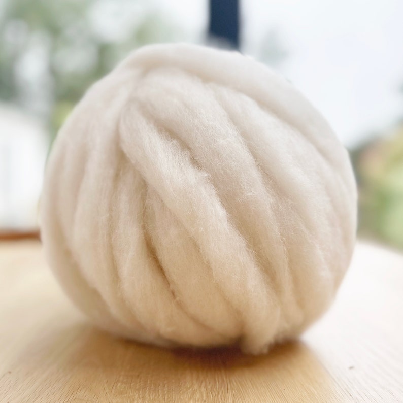 May include: A large ball of white yarn, perfect for knitting or crocheting.