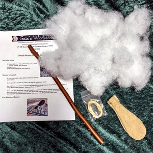 May include: A pouch beater kit with instructions, a brown wooden stick, a pouch, a bag of white stuffing, and a length of twine. The instructions include the text "Pouch Beater Making Instructions".