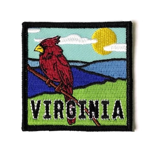 May include: Embroidered patch featuring a red cardinal perched on a branch against a green, blue, and yellow landscape. The word "VIRGINIA" is stitched in black letters below the bird.