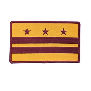 May include: A yellow and maroon embroidered patch with three yellow stars and three maroon stripes. The patch is surrounded by a maroon border.