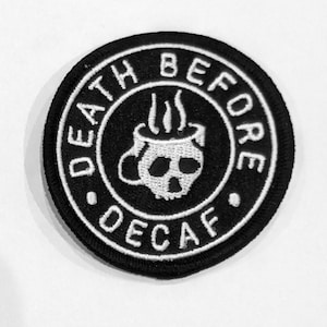 May include: Black and white embroidered patch with the text "DEATH BEFORE DECAF" in a circle around a skull and crossbones in a coffee cup.