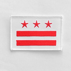 May include: White embroidered patch with three red stars and two red stripes, representing the flag of Washington, D.C.