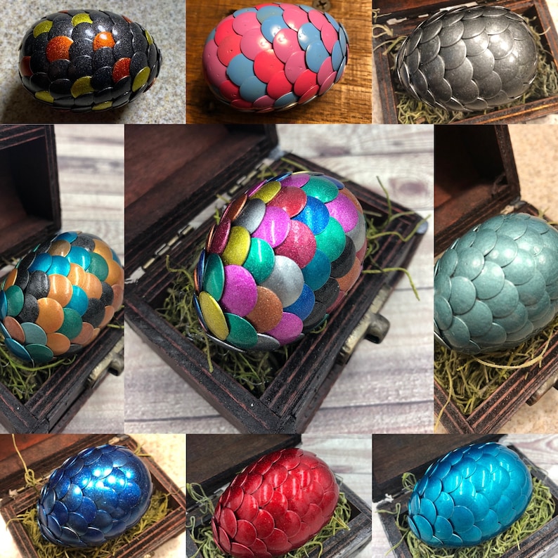 May include: Ten decorative eggs with a mosaic pattern. Each egg is a different color, including black, pink, teal, blue, and green. The eggs are arranged in a grid pattern on a white background.