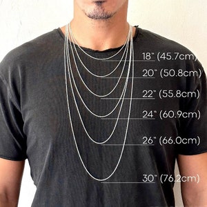 May include: A person wearing a black t-shirt with several silver chain necklaces of varying lengths. The necklaces range from 18 inches (45.7cm) to 30 inches (76.2cm) in length, with measurements clearly labeled.