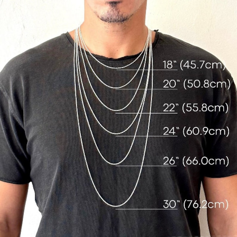 May include: A person wearing a black t-shirt with several silver chain necklaces of varying lengths. The necklaces range from 18 inches (45.7cm) to 30 inches (76.2cm) in length, with measurements clearly labeled.