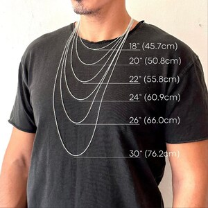 May include: A person wearing a black t-shirt with several silver chain necklaces of varying lengths. The necklaces are labeled with their lengths: 18" (45.7cm), 20" (50.8cm), 22" (55.8cm), 24" (60.9cm), 26" (66.0cm), and 30" (76.2cm).