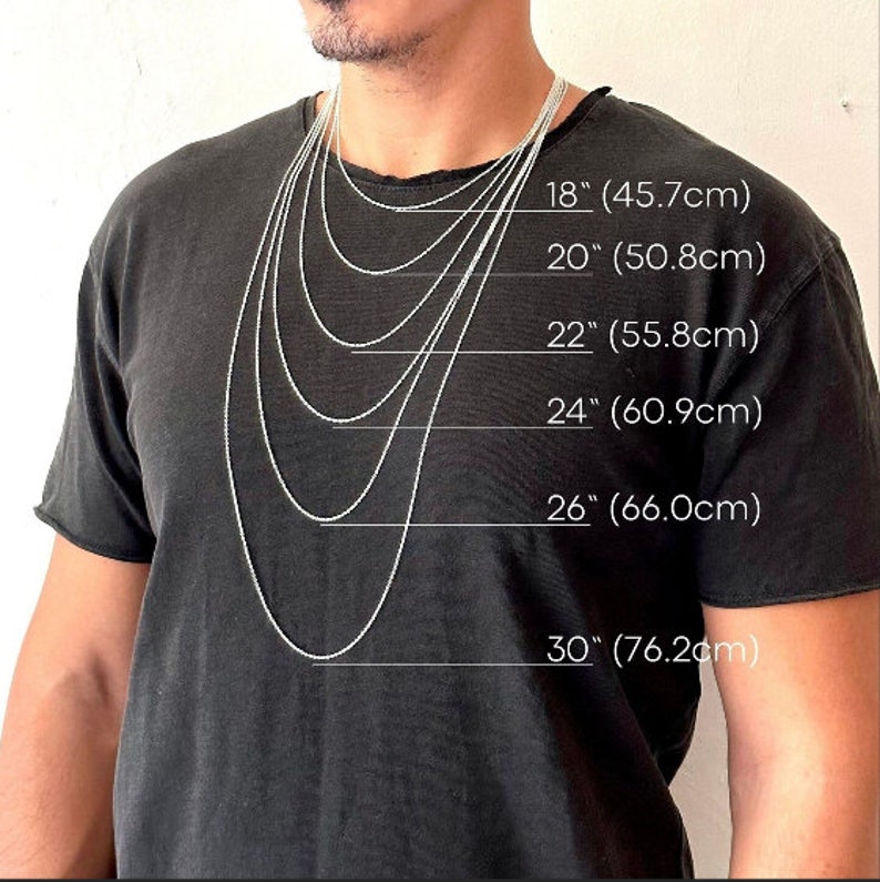 May include: A person wearing a black t-shirt with several silver chain necklaces of varying lengths. The necklaces are labeled with their lengths: 18" (45.7cm), 20" (50.8cm), 22" (55.8cm), 24" (60.9cm), 26" (66.0cm), and 30" (76.2cm).