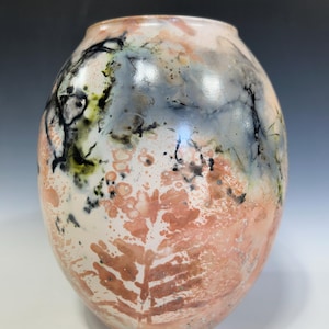 May include: A white ceramic mug with a black handle and the text "But First, Coffee" in a black, bold font. The mug is on a white surface. The mug is approximately 4 inches tall.