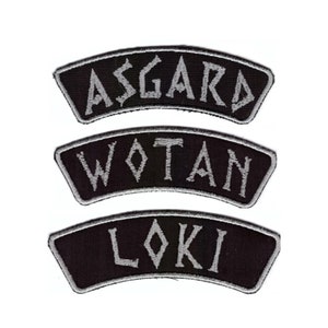 May include: Three black fabric patches with white embroidered text. The patches read "Asgard", "Wotan", and "Loki".