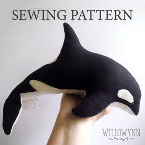 May include: A black and white plush orca sewing pattern. The pattern is for a stuffed animal that is about 12 inches long. The pattern is available for download.