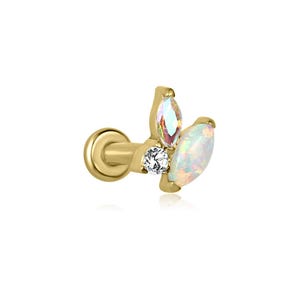 May include: A gold-colored ear piercing stud with three decorative stones. The stones include a clear, round-cut stone, an iridescent marquise-cut stone, and a white, oval-cut stone. The stud has a flat back and a curved post.