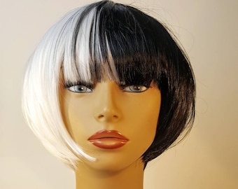 May include: A short, straight wig with a black and white color scheme. The wig is styled with a side part and a blunt fringe.