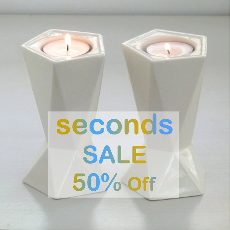 A Pair of Shabbat candlesticks made in Israel and designed in geometric style. These two sided candle holders fits tall celebrative Shabbat candles. The candlesticks are covered in beautiful white glaze. Now for 50% sale!