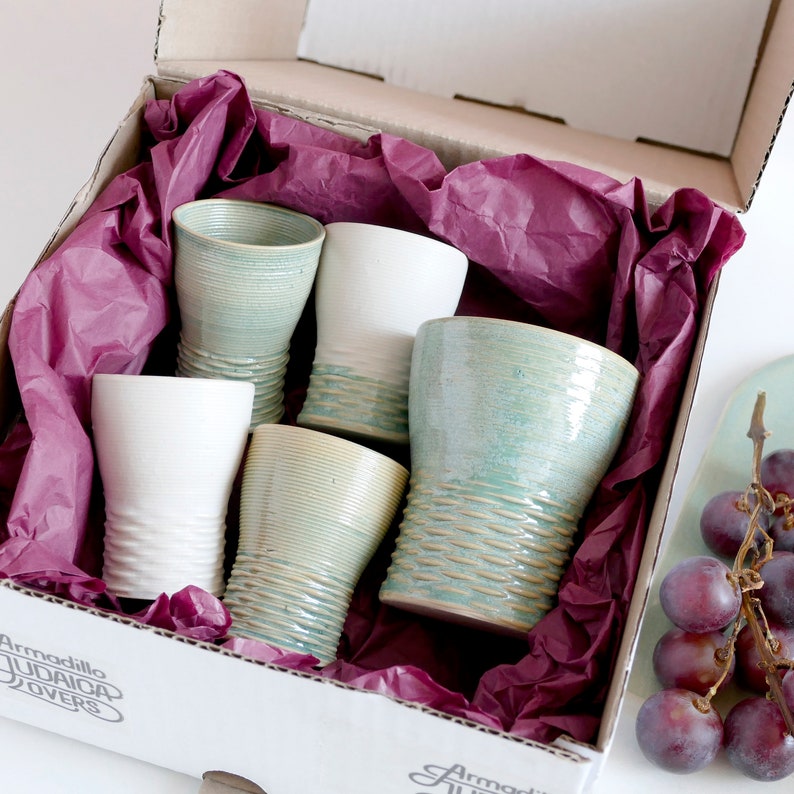 Mystery box of Kiddush cups set - The box's contents stay the same - the glazes varies in off white, beige and mint green shades!
Pictures show different combinations of glazes - the exact colors combination of your set is a surprise.