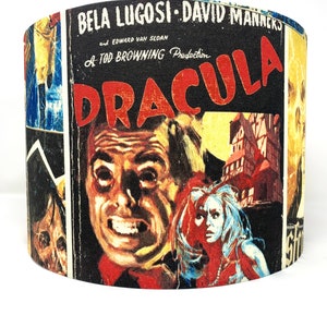 May include: A vintage-style lampshade featuring a collage of images from the 1931 film "Dracula." The lampshade features a close-up of Bela Lugosi as Dracula, along with other scenes from the film, including a woman with a pearl necklace and a castle.