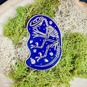 Velociraptor Skeleton Enamel Pin: Gold & Blue Dinosaur Fossil