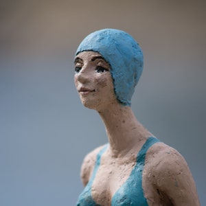 Sculpture Delphín. Girl swimmer.