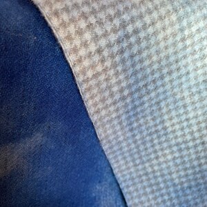 light blue hand dyed houndstooth wool fabric and a dark royal blue plain hand dyed wool fabric