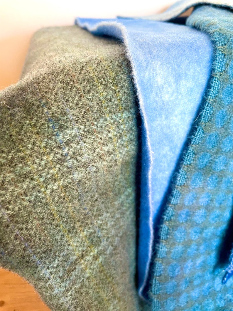three shades of hand dyed blue wools on three different textured wools