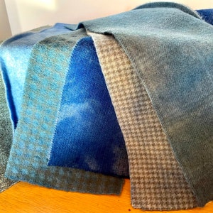 Display of six different hand dyed blue wools. Lights, darks, checked, plaid and houndstooth
