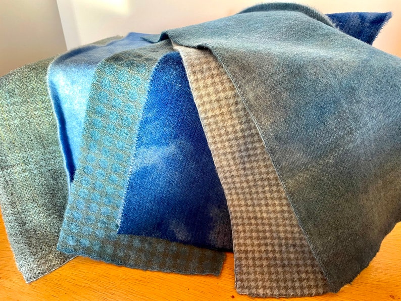 Display of six different hand dyed blue wools. Lights, darks, checked, plaid and houndstooth