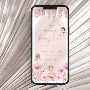 May include: A smartphone displays a pink fairy-themed birthday party invitation. The invitation features the text "Olivia's fairy first" with illustrations of fairies, flowers, and the date May 28, 2025. The phone is set against a light pink background.