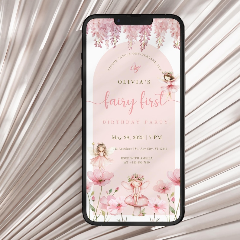 May include: A smartphone displays a pink fairy-themed birthday party invitation. The invitation features the text "Olivia's fairy first" with illustrations of fairies, flowers, and the date May 28, 2025. The phone is set against a light pink background.