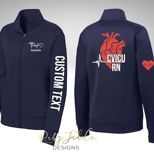 May include: Navy blue zip-up jacket with white text "CUSTOM TEXT" on the sleeve. The front features a medical symbol and the name "Amanda". The back displays a red heart graphic with "CVICU RN" and a heartbeat line. A red heart is on the right sleeve.