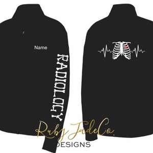 May include: Black zippered jacket with a white ribcage and heartbeat graphic on the front and the word "RADIOLOGY" written vertically down the left sleeve in white. The jacket has a name tag on the left chest.
