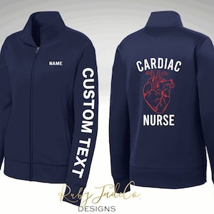 May include: Navy blue zippered jacket with the text "CARDIAC NURSE" and a red anatomical heart on the back. The left sleeve has the text "CUSTOM TEXT" and the text "NAME" is on the front.