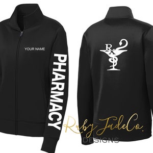 May include: Black fleece jacket with a zipper closure and a white "Pharmacy" print on the left sleeve. The back of the jacket has a white pharmacy symbol with the letters "Rx" and a snake wrapped around a cup.