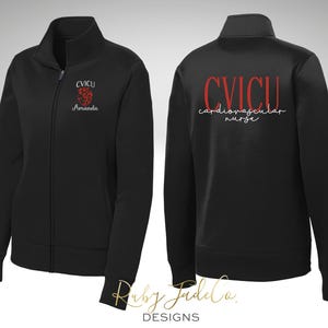 May include: Black zip-up jacket with red embroidery. The front reads "CVICU Amanda" with a red heart graphic. The back reads "CVICU cardiovascular nurse".