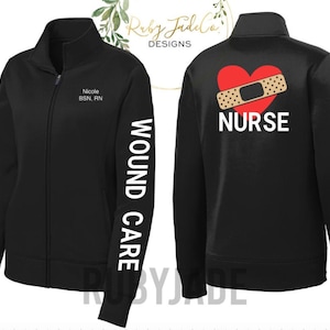 May include: Black zippered jacket with the text "WOUND CARE" on the left sleeve and the text "NURSE" with a red heart and bandage on the back.
