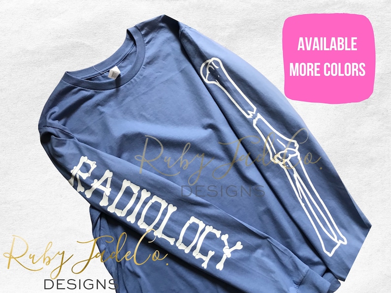 May include: A blue long-sleeve t-shirt with a white skeleton arm design on the sleeve and the word "RADIOLOGY" spelled out in white bones. The text "AVAILABLE MORE COLORS" is in a pink box in the upper right corner of the image.