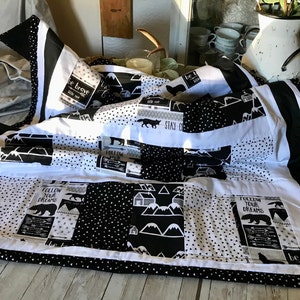 Introducing my stunning black and white 46x35 baby quilt, adorned with a powerful and inspiring message: "Be Brave."