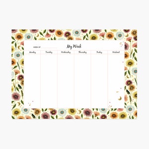 Peut inclure: Un planificateur hebdomadaire avec un motif floral. Le planificateur a un fond crème avec une bordure de fleurs colorées et de lunes. Les jours de la semaine sont listés en haut : Lundi, Mardi, Mercredi, Jeudi, Vendredi et Week-end. Le texte "Ma Semaine" est centré en haut du planificateur.