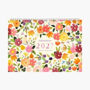 May include: A 2027 wall calendar with a spiral binding, featuring a cream background covered in colourful watercolour illustrations of various flowers, autumn leaves, and two cats. The text reads "calendrier 2027" and "SONIA CAVALLINI" in the centre.
