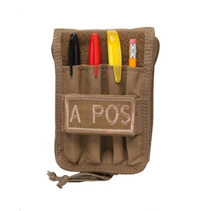 May include: A tan zippered pouch with multiple slots for pens and pencils. The pouch has a velcro patch that says "A POS".