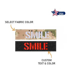 May include: Two rectangular patches with the word "SMILE" in bold letters. One patch has a camouflage pattern with white letters, and the other is black with red letters. The image also includes the text "SELECT FABRIC COLOR" and "CUSTOM TEXT & COLOR".