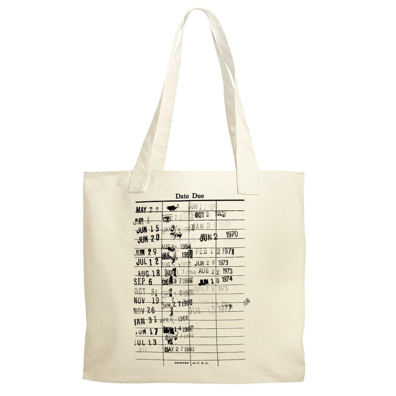 A beige tote bag with a printed list of dates and events printed on it.
