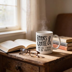 A mug with the text "Books & Coffee are all I need to be happy" sits on a wooden table next to a pair of glasses and a stack of books.
