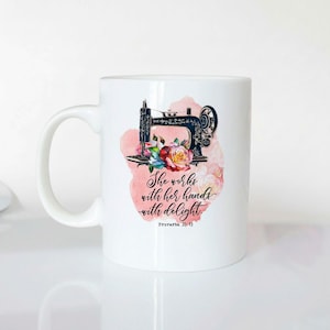 A white ceramic mug with a printed design featuring a sewing machine and flowers, along with a Bible verse from Proverbs 3:5-13.