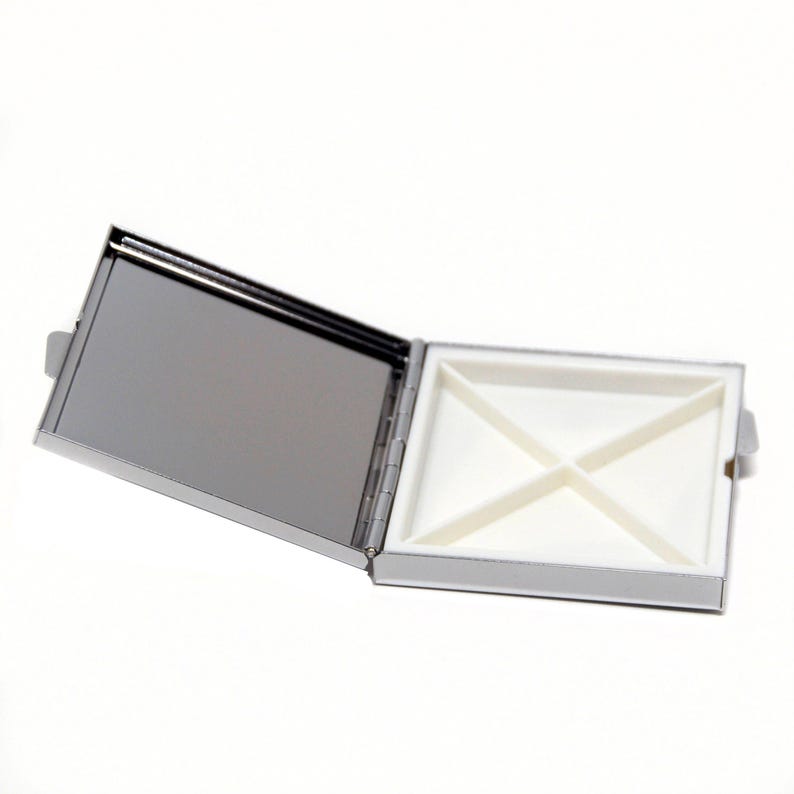 An open square box with a white interior, placed on a white background.