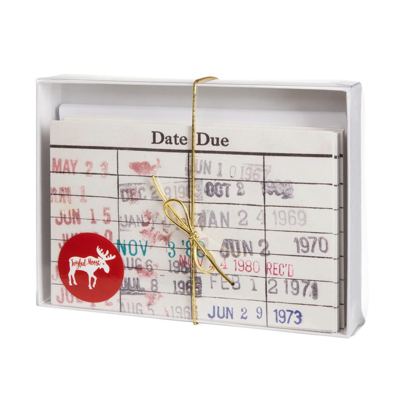 A white box containing a set of date due cards, each with a red moose sticker.