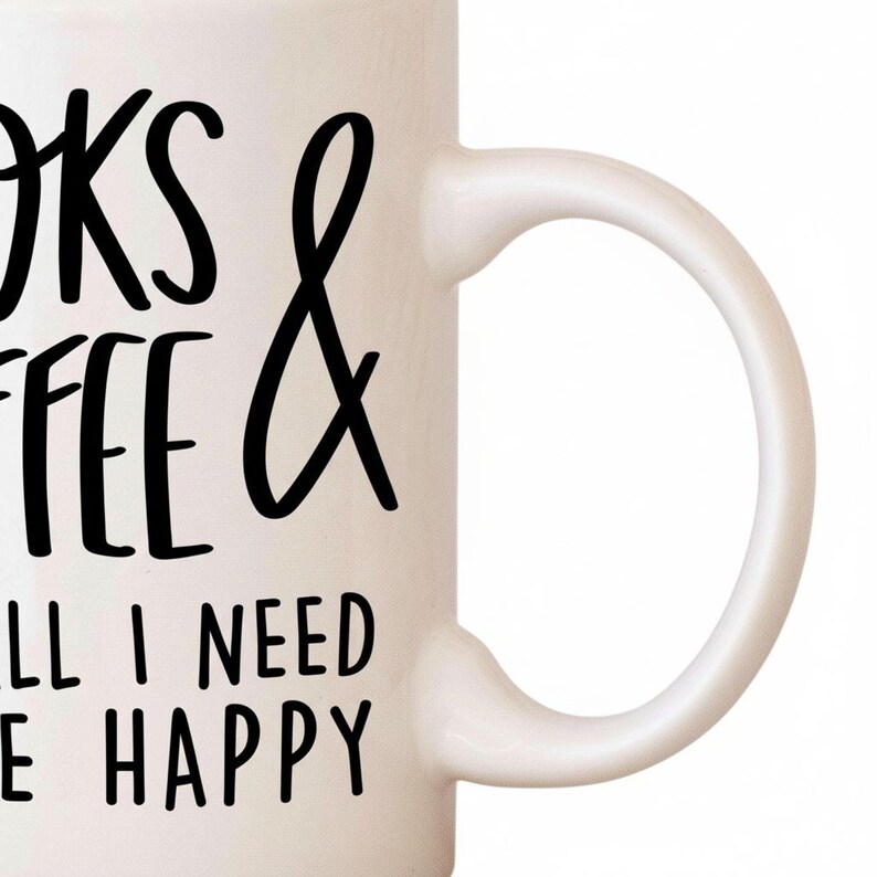 A white mug with black text that says "I need coffee and books to be happy".