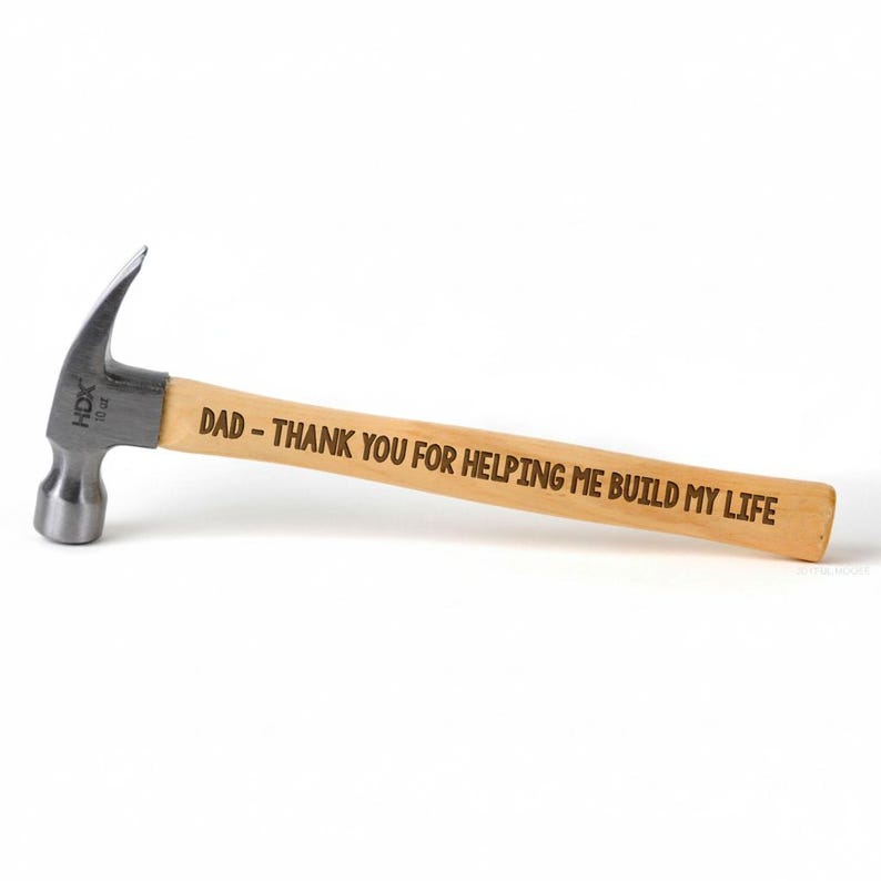 A wooden hammer with a engraved message on it.