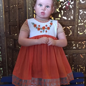 Girl&#39;s Mexican orange dress  with Flowers.Includes matching flowers  headband.First year, birthday
