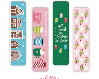 May include: Set of three Christmas-themed bookmarks. The first bookmark features a blue background with gingerbread houses. The second bookmark features a pink background with a pattern of mugs and hot chocolate. The third bookmark features a pink background with a pattern of candy canes and snowflakes. The text on the second bookmark reads "have a cup of cheer". The text on the third bookmark reads "all I want for Christmas is books".