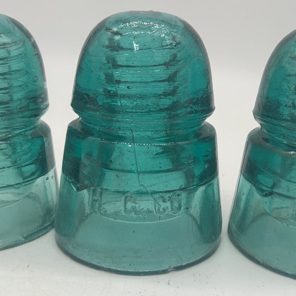 Vintage aqua colored glass H.G. CO. glass insulator w/ 1/2" hole for DIY projects