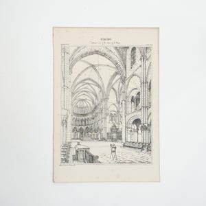 May include: An antique architectural print of a cathedral interior. The black and white illustration depicts arched ceilings, columns, and detailed architectural elements. The print has the word "REIMS" at the top.